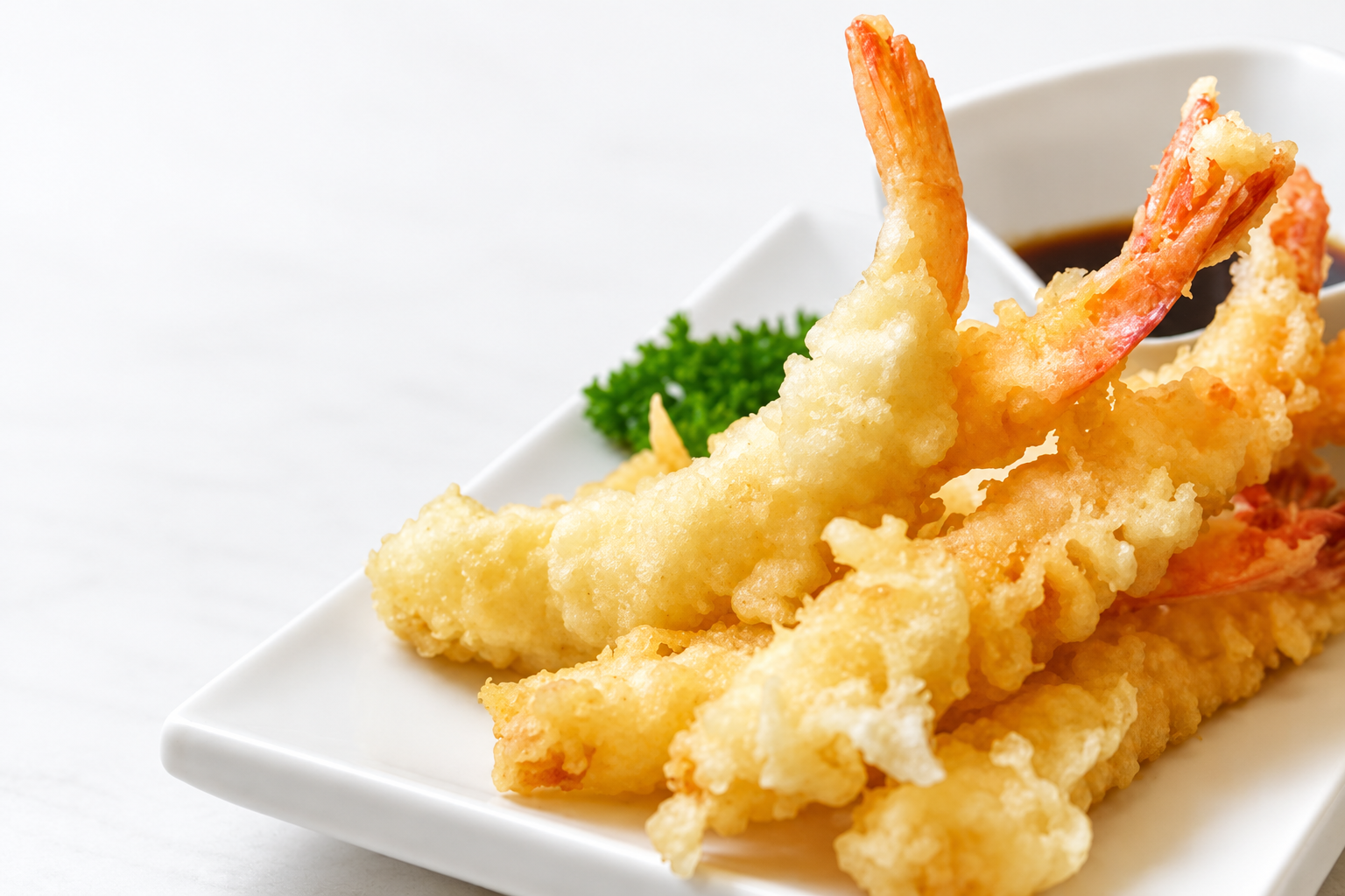 Crispy shrimp tempura on a white plate
